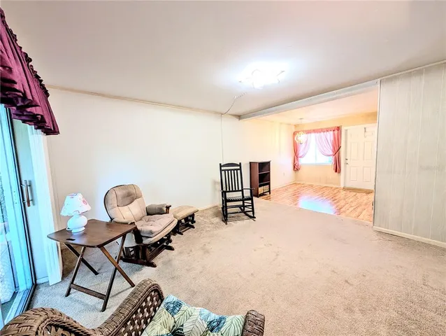 a living room with furniture a rug and a large window