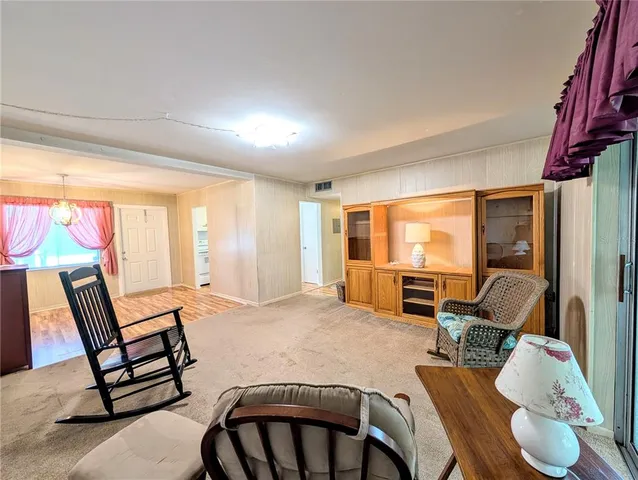 a room with wooden floor and windows