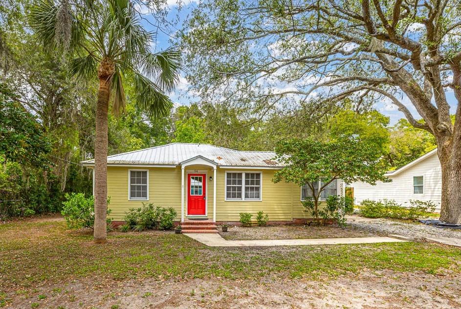 54 Maxwell Avenue St. Simons, GA 31522 - Photo 1 of 1 a front view of a house with a yard and garage