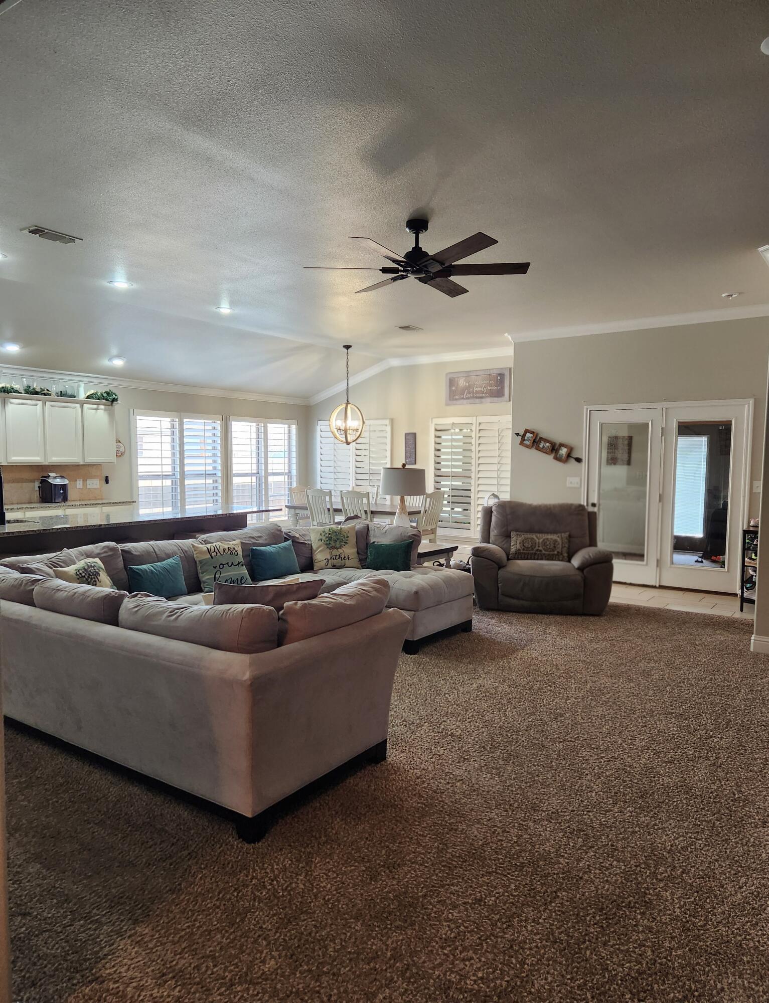 7217 91st Street Lubbock, TX 79424 - Photo 11 of 27 a living room with furniture and a ceiling fan