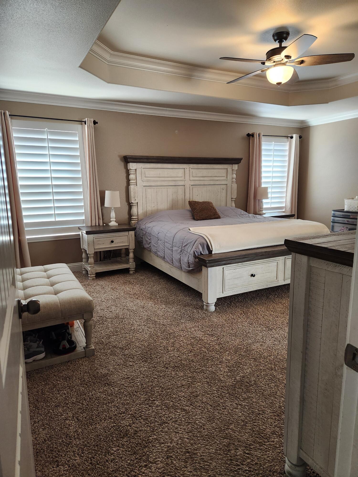 7217 91st Street Lubbock, TX 79424 - Photo 15 of 27 a bedroom with a bed and a chandelier