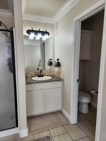 a spacious bathroom with a granite countertop sink and a mirror
