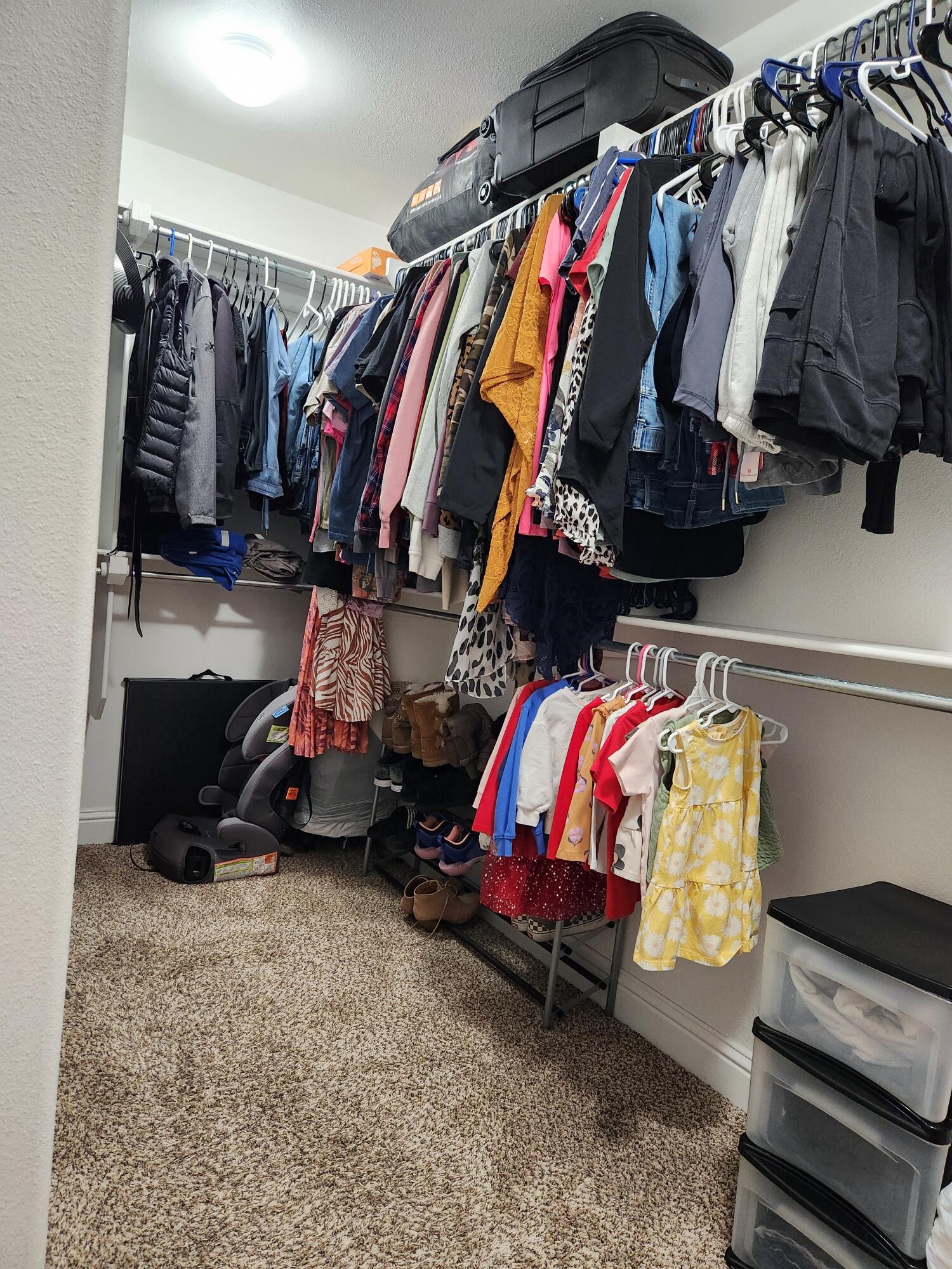 7217 91st Street Lubbock, TX 79424 - Photo 22 of 27 a view of walk in closet with clothes and shoes