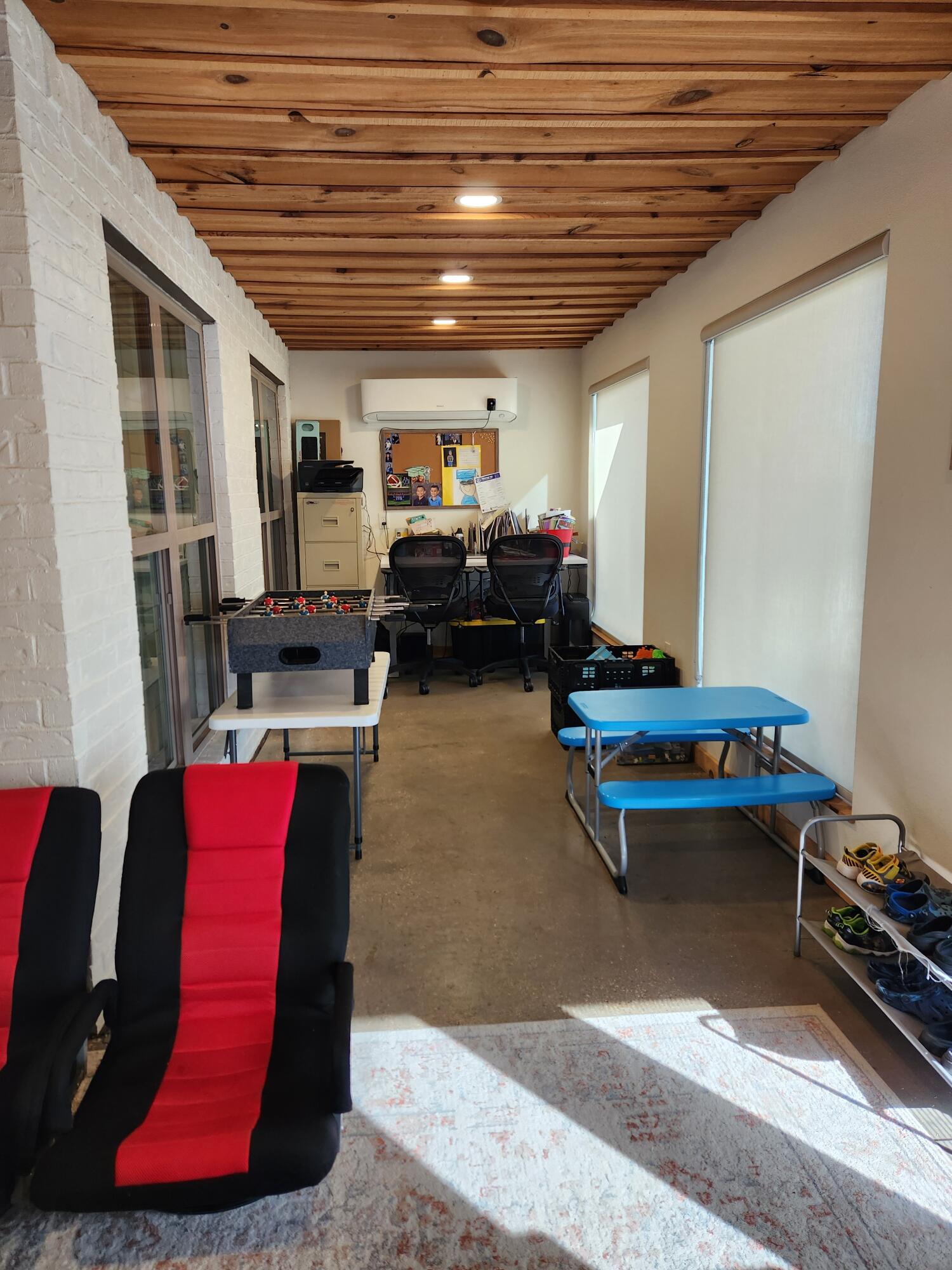 7217 91st Street Lubbock, TX 79424 - Photo 23 of 27 a living room with furniture gym equipment and a table