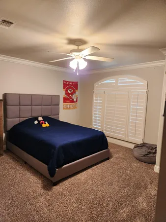 a bedroom with a bed and gym equipment