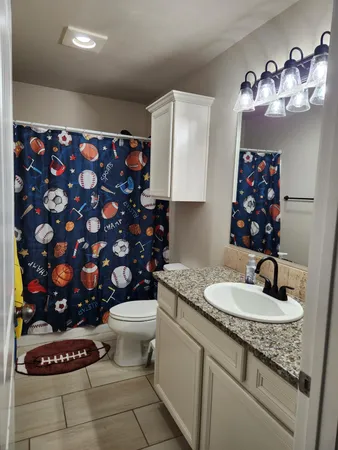 a bathroom with a sink toilet and a mirror