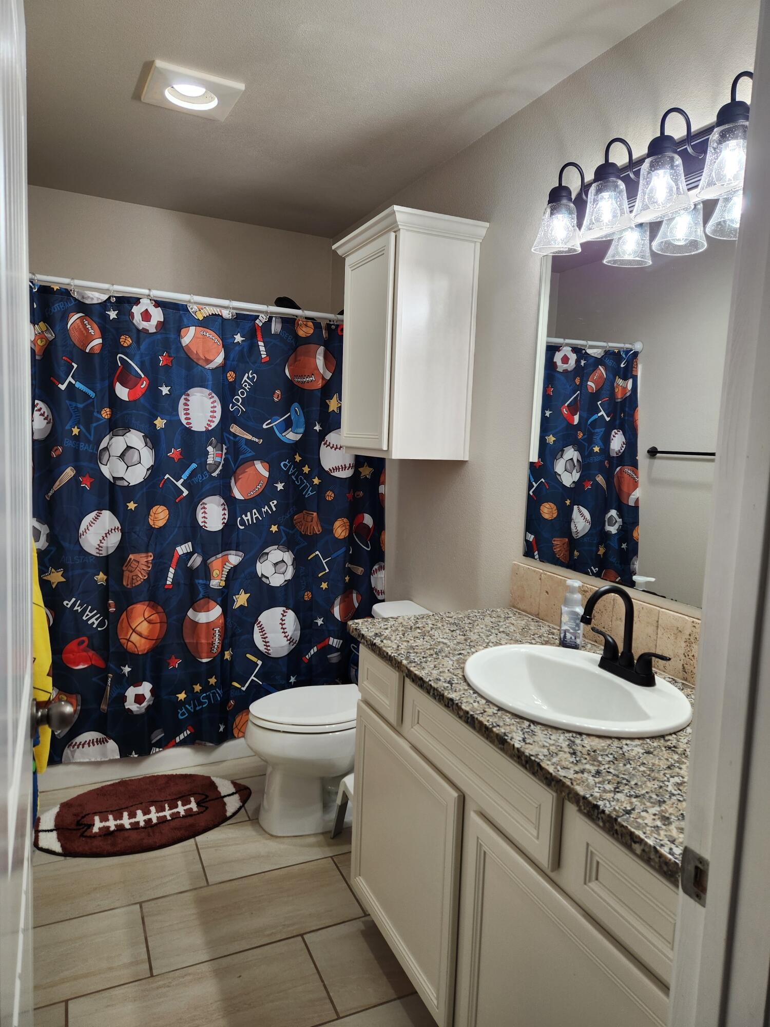 7217 91st Street Lubbock, TX 79424 - Photo 4 of 27 a bathroom with a sink toilet and a mirror