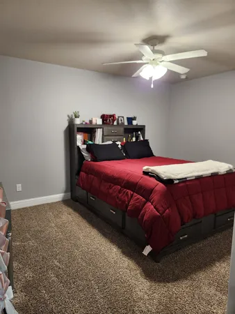 a bedroom with a bed and a chandelier