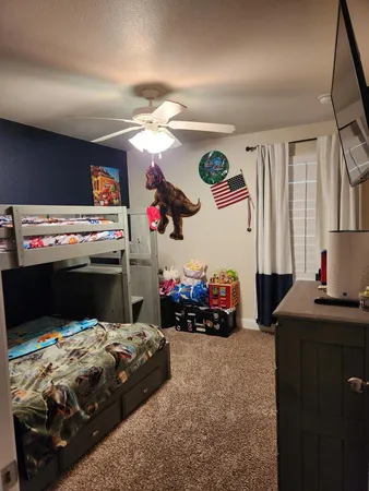 a bedroom with a bed and a chandelier