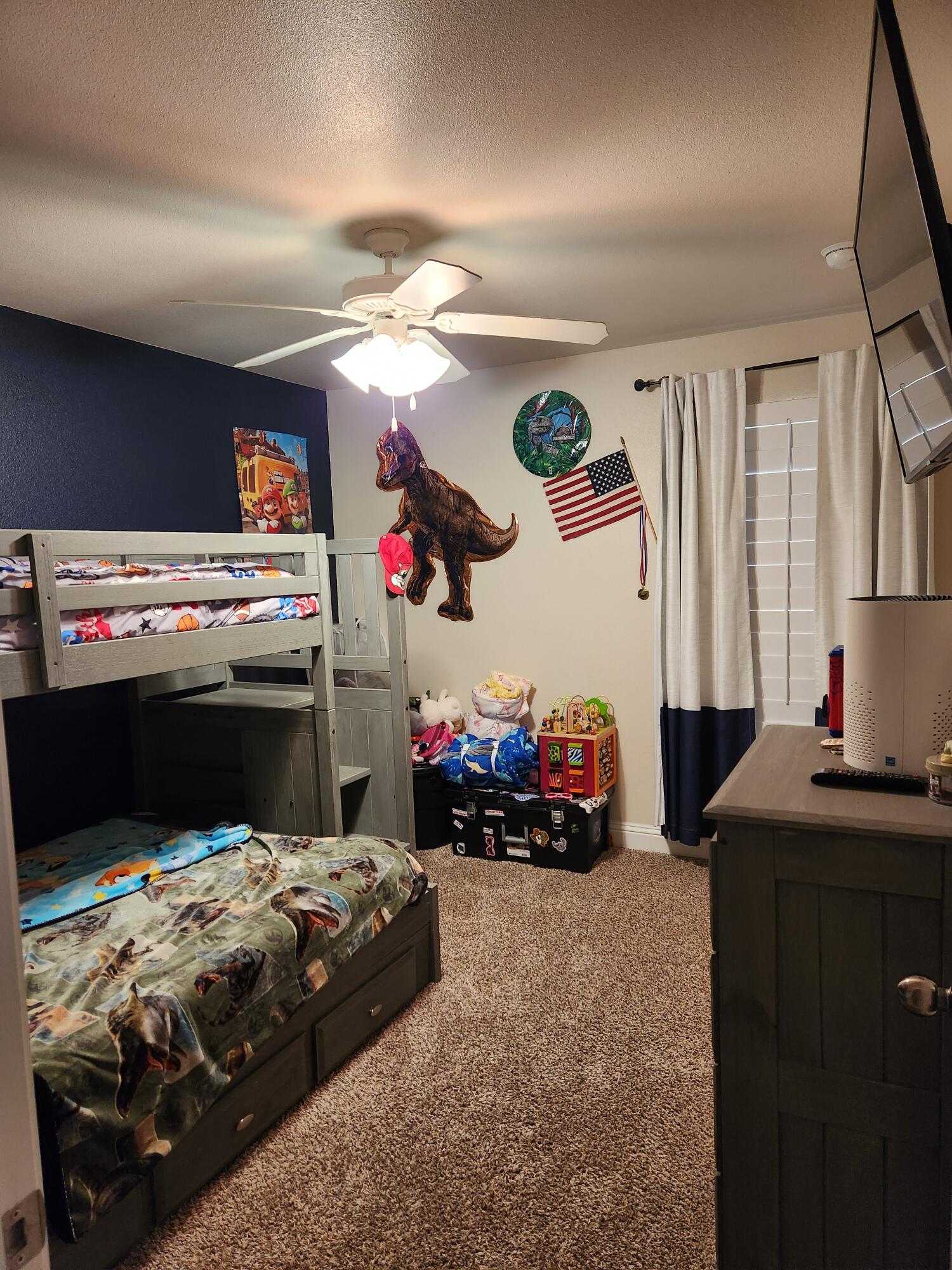 7217 91st Street Lubbock, TX 79424 - Photo 7 of 27 a bedroom with a bed and a chandelier
