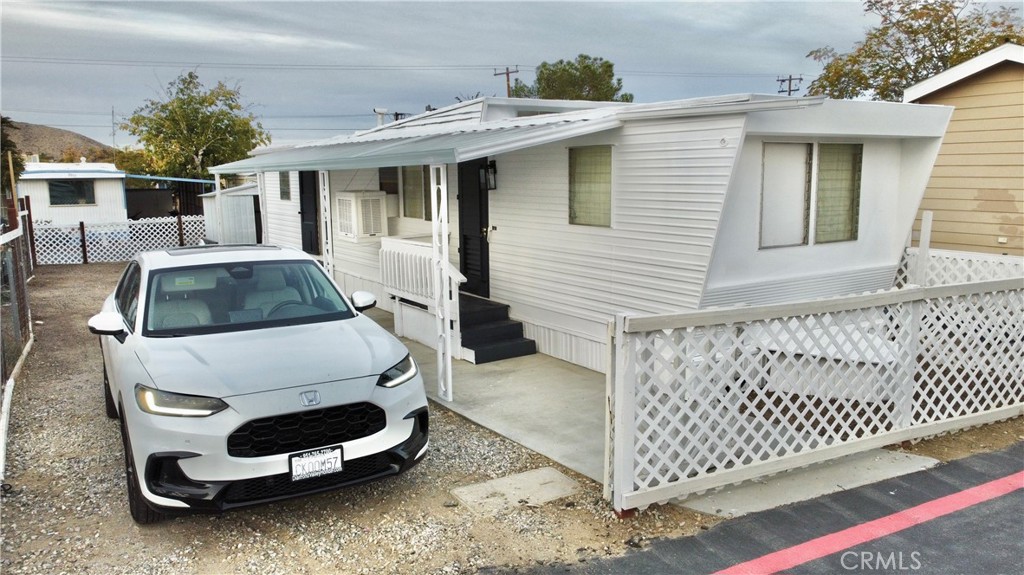 a car parked in front of a white house
