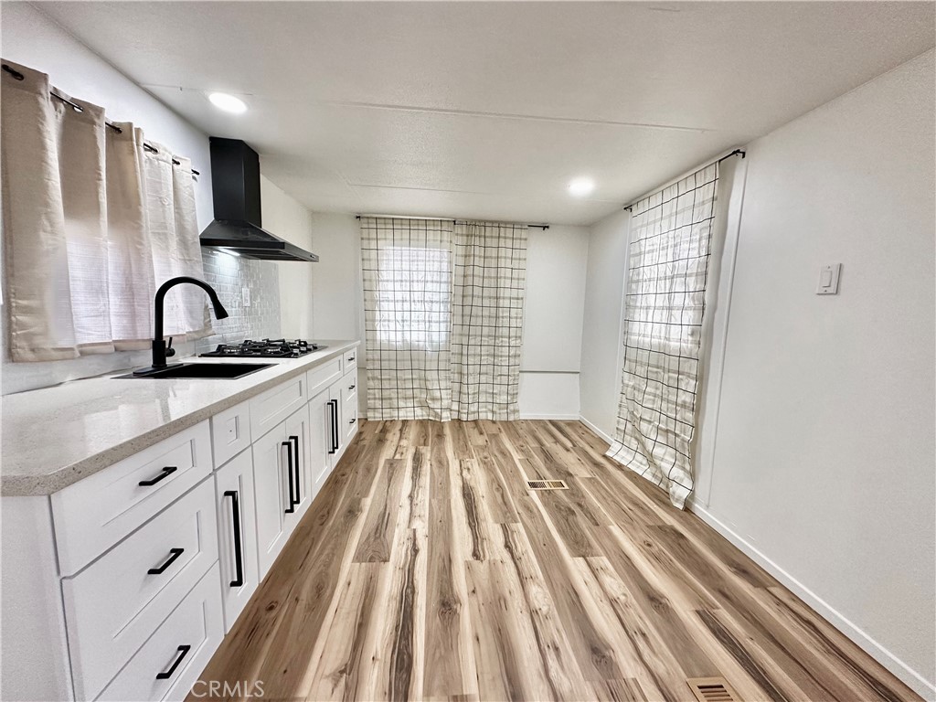 6426 Valley View Street, Unit 9 Joshua Tree, CA 92252 - Photo 13 of 23 a kitchen with sink a refrigerator and cabinets