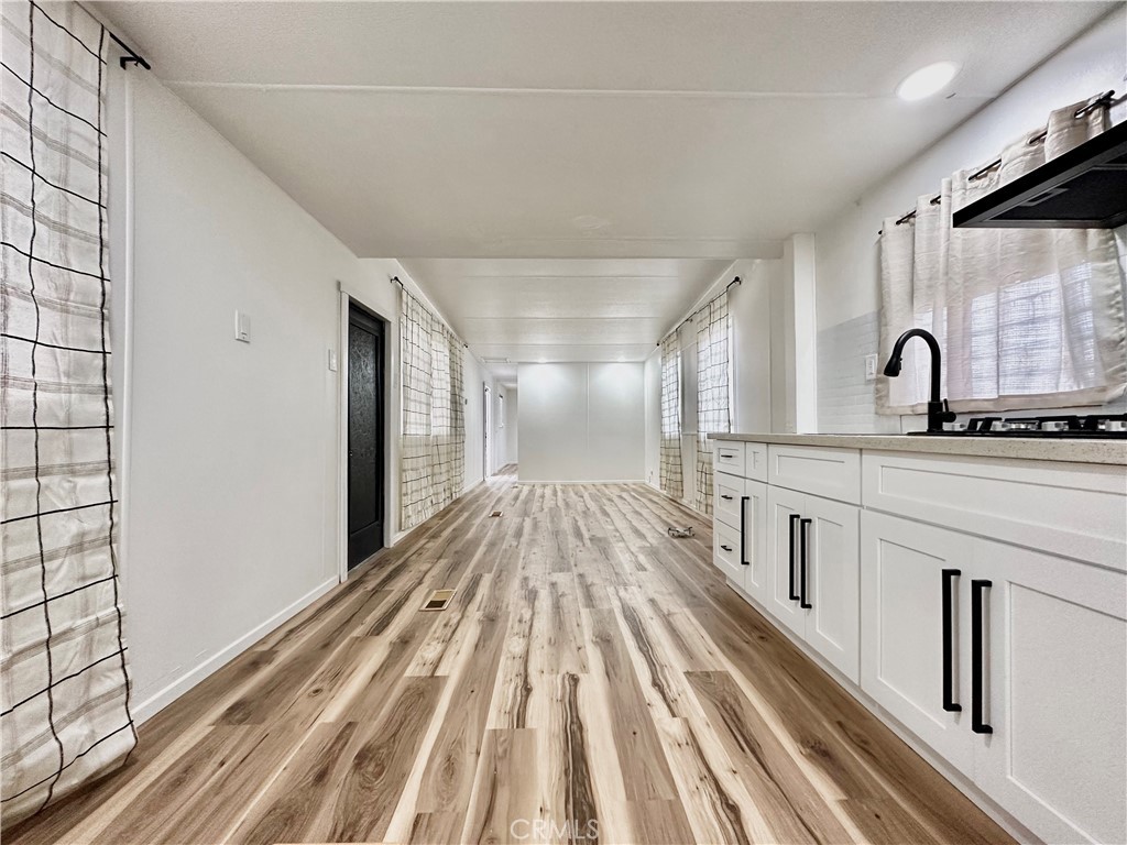 6426 Valley View Street, Unit 9 Joshua Tree, CA 92252 - Photo 14 of 23 a view of a kitchen with wooden floor and cabinets