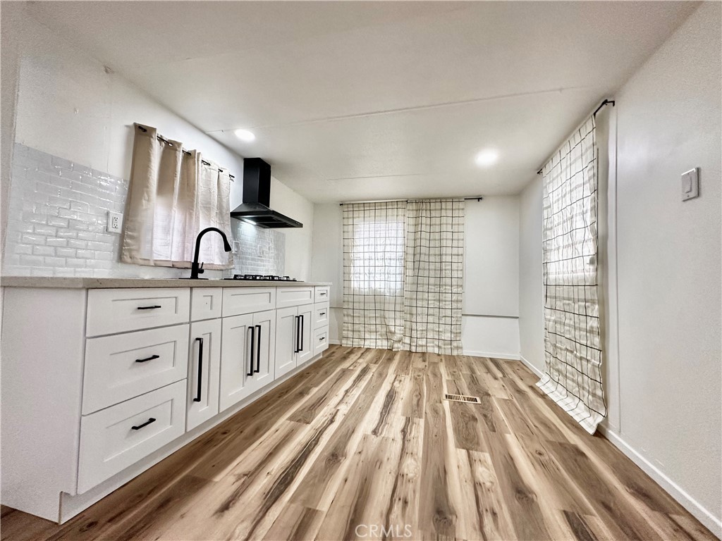 6426 Valley View Street, Unit 9 Joshua Tree, CA 92252 - Photo 15 of 23 a kitchen with granite countertop white cabinets and white appliances