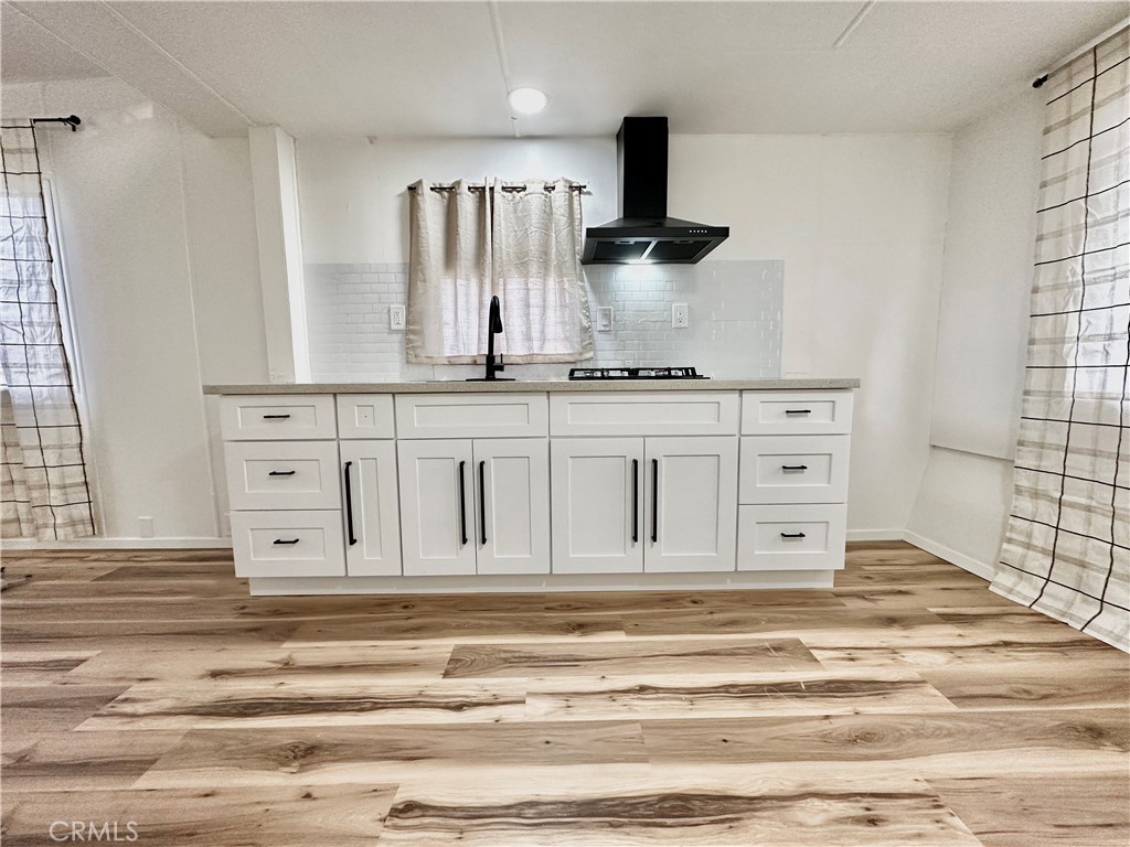 6426 Valley View Street, Unit 9 Joshua Tree, CA 92252 - Photo 16 of 23 a view of kitchen with granite countertop white cabinets and a sink