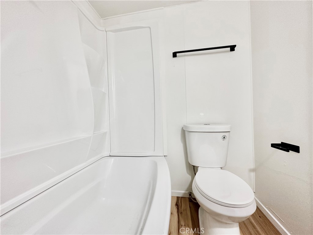 6426 Valley View Street, Unit 9 Joshua Tree, CA 92252 - Photo 10 of 23 a white toilet sitting next to a bath tub