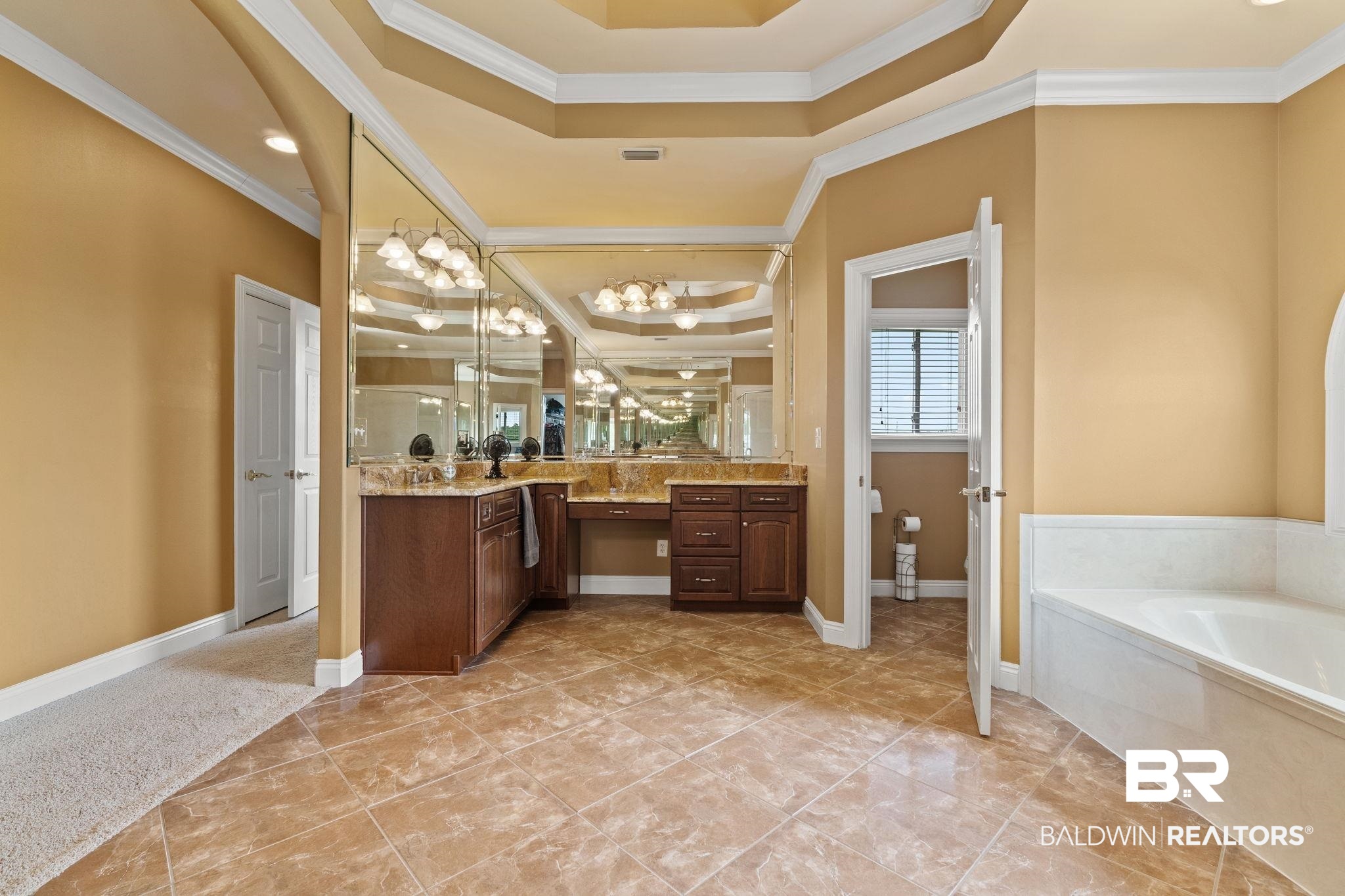 9790 Stucki Road Elberta, AL 36530 - Photo 65 of 72 Bathroom featuring crown molding, vanity, a tray ceiling, a garden tub, and a shower