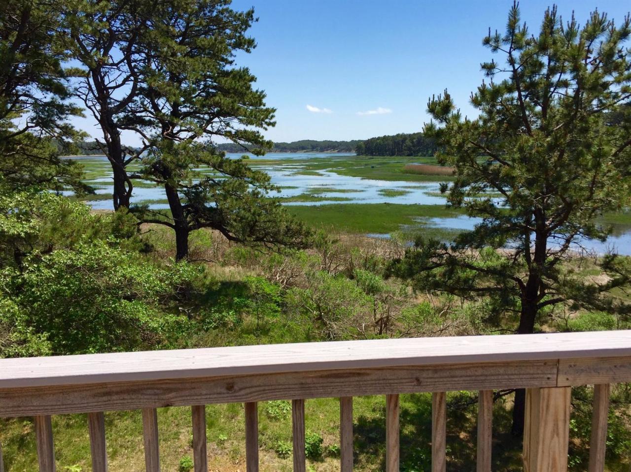 345 Pilgrim Spring Road Wellfleet, MA 02667 - Photo 2 of 18 a view of a lake from a balcony