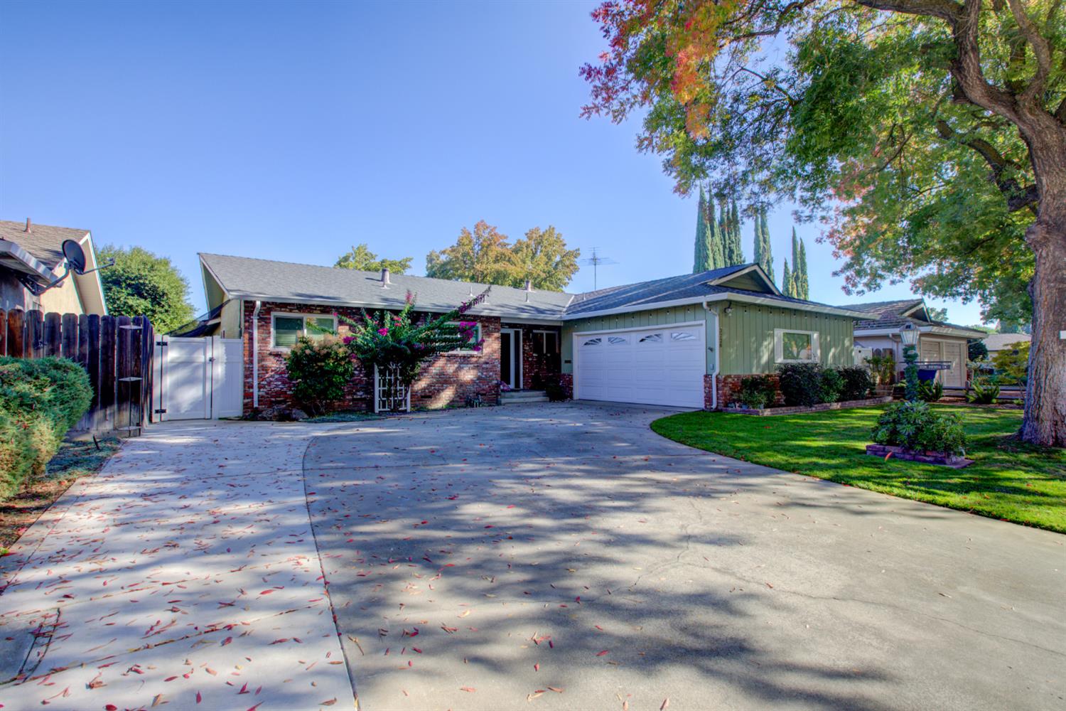 a front view of a house with a yard and a garage