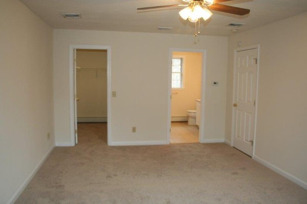 206 Boxford Road Haverhill, MA 01835 - Photo 8 of 11 an empty room with a chandelier fan and a bathroom