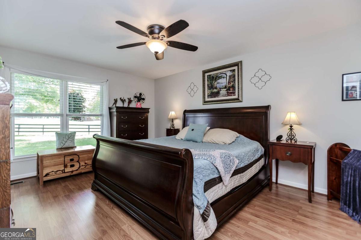 6441 Hog Mountain Road Bogart, GA 30622 - Photo 16 of 57 a bed room with furniture and a fireplace