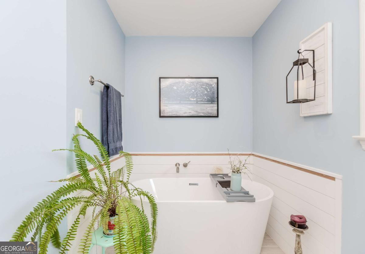 6441 Hog Mountain Road Bogart, GA 30622 - Photo 20 of 57 a bathroom with a sink a mirror and a bathtub