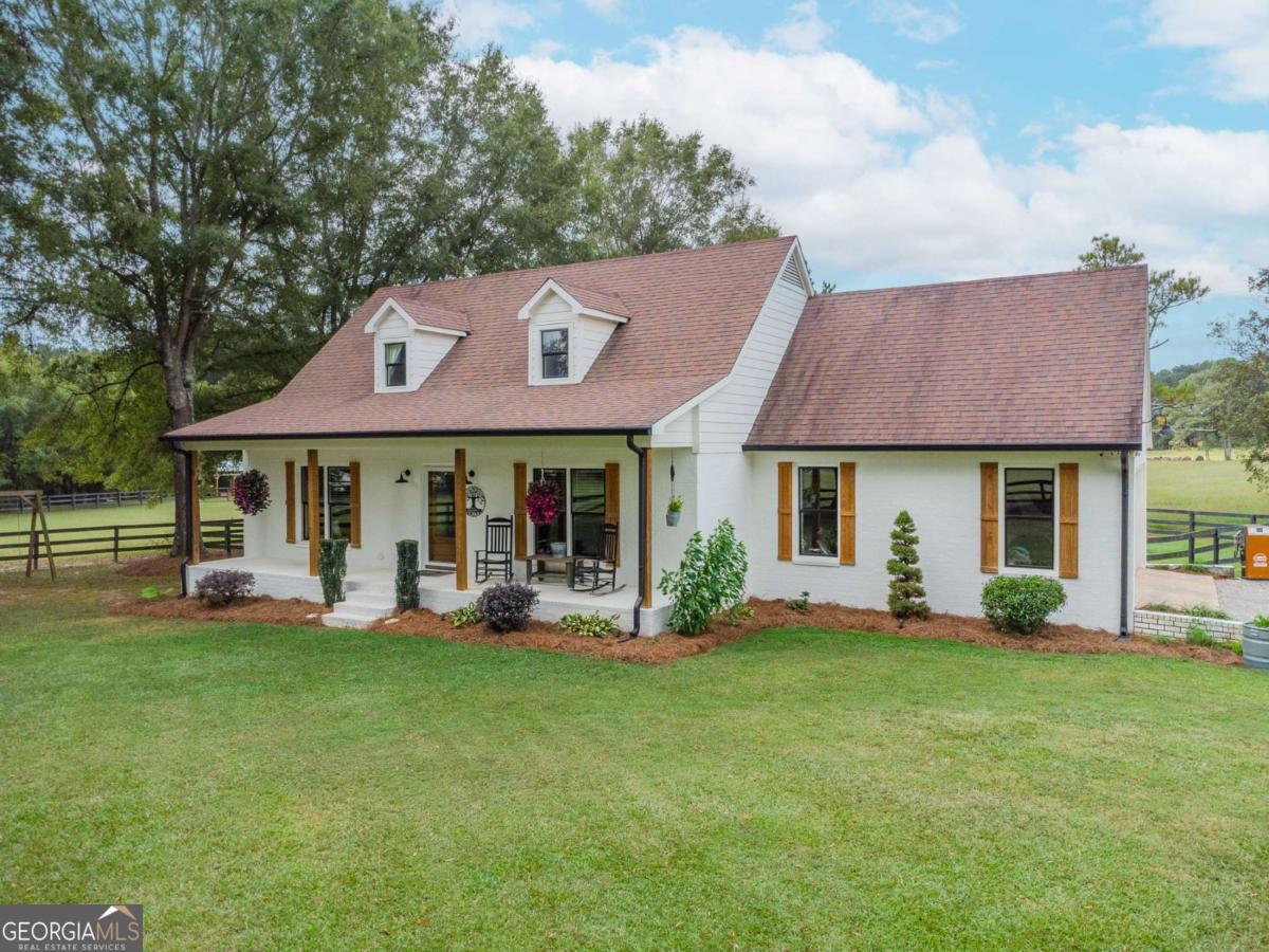 6441 Hog Mountain Road Bogart, GA 30622 - Photo 2 of 57 a front view of a house with garden and porch