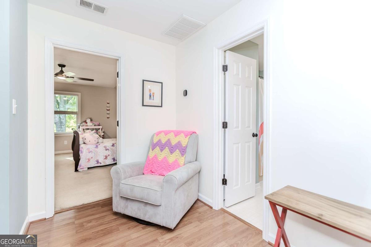 6441 Hog Mountain Road Bogart, GA 30622 - Photo 22 of 57 a bedroom with furniture and a wooden floor