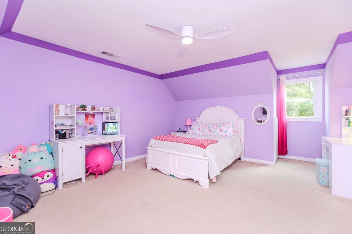 6441 Hog Mountain Road Bogart, GA 30622 - Photo 23 of 57 a bedroom with pink bed and a chandelier