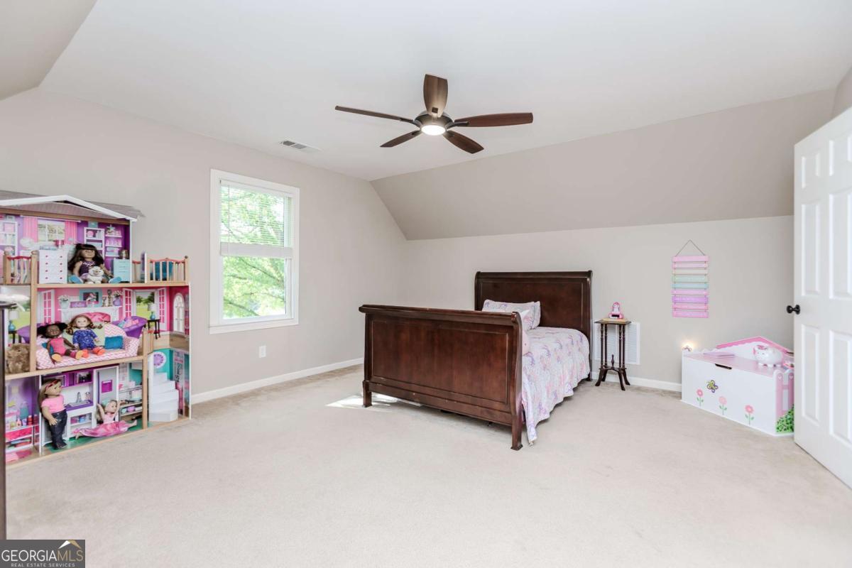 6441 Hog Mountain Road Bogart, GA 30622 - Photo 26 of 57 a bedroom with furniture and a baby crib