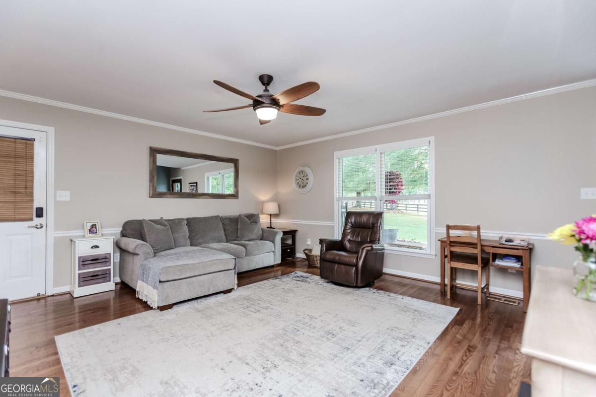 6441 Hog Mountain Road Bogart, GA 30622 - Photo 3 of 57 a living room with furniture ceiling fan and a window