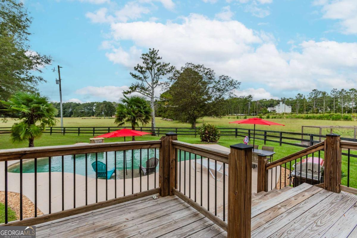 6441 Hog Mountain Road Bogart, GA 30622 - Photo 32 of 57 a view of a deck and trees with wooden fence