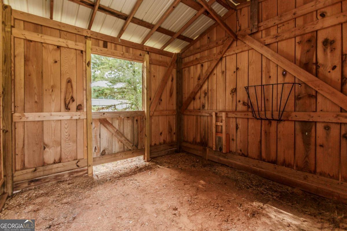 6441 Hog Mountain Road Bogart, GA 30622 - Photo 40 of 57 a view of an empty room with wooden walls