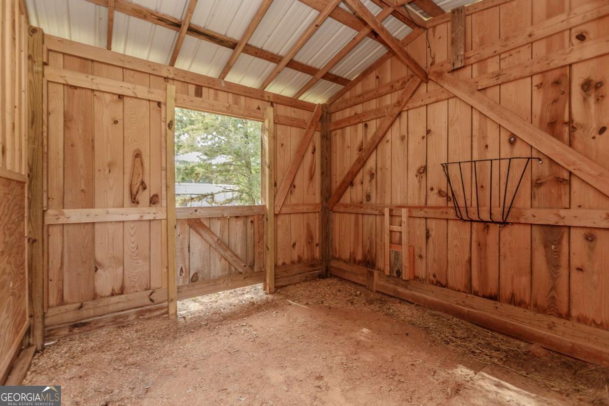 6441 Hog Mountain Road Bogart, GA 30622 - Photo 41 of 57 an empty room with wooden floor and windows