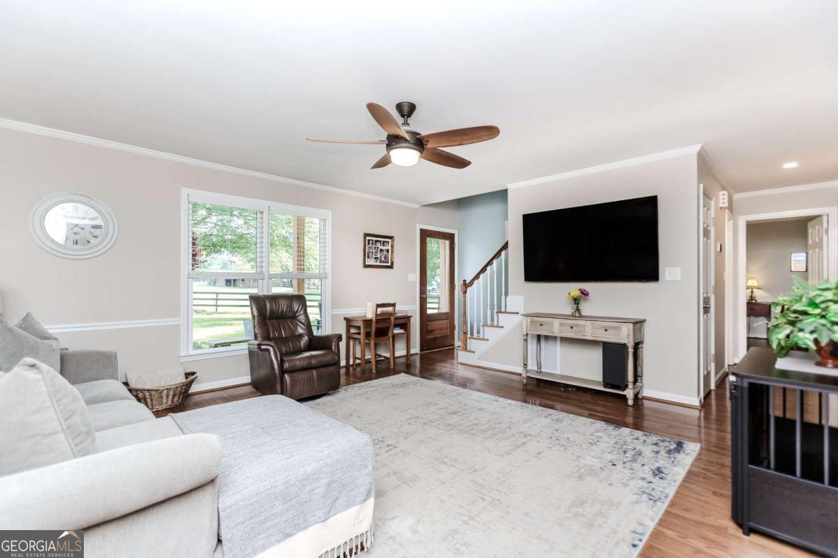 6441 Hog Mountain Road Bogart, GA 30622 - Photo 5 of 57 a living room with furniture and a flat screen tv
