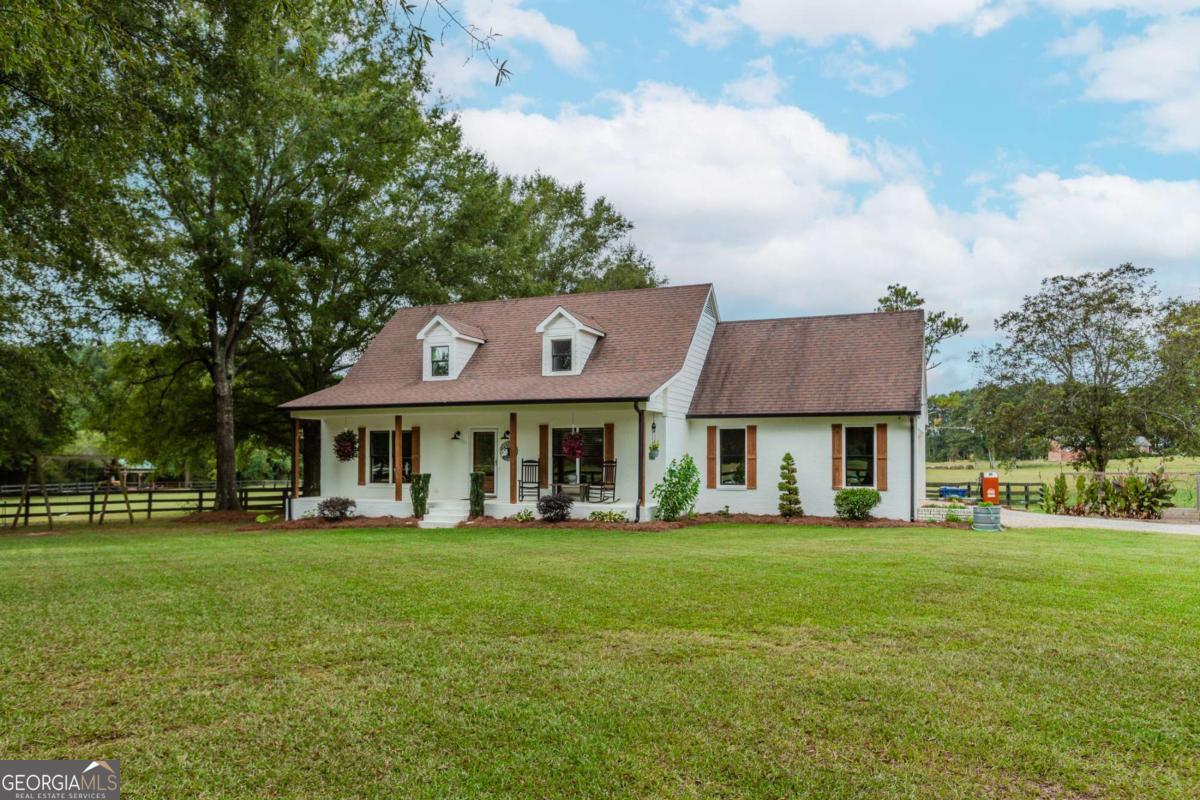 6441 Hog Mountain Road Bogart, GA 30622 - Photo 54 of 57 a front view of a house with a garden and trees