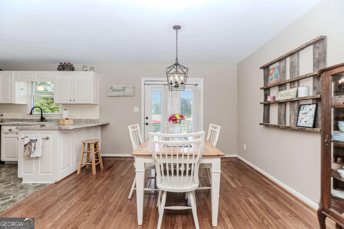 6441 Hog Mountain Road Bogart, GA 30622 - Photo 7 of 57 a view of a dining room with furniture window and wooden floor