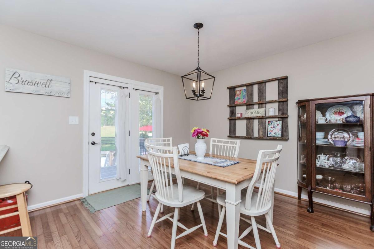 6441 Hog Mountain Road Bogart, GA 30622 - Photo 8 of 57 a dining room with furniture a chandelier and wooden floor