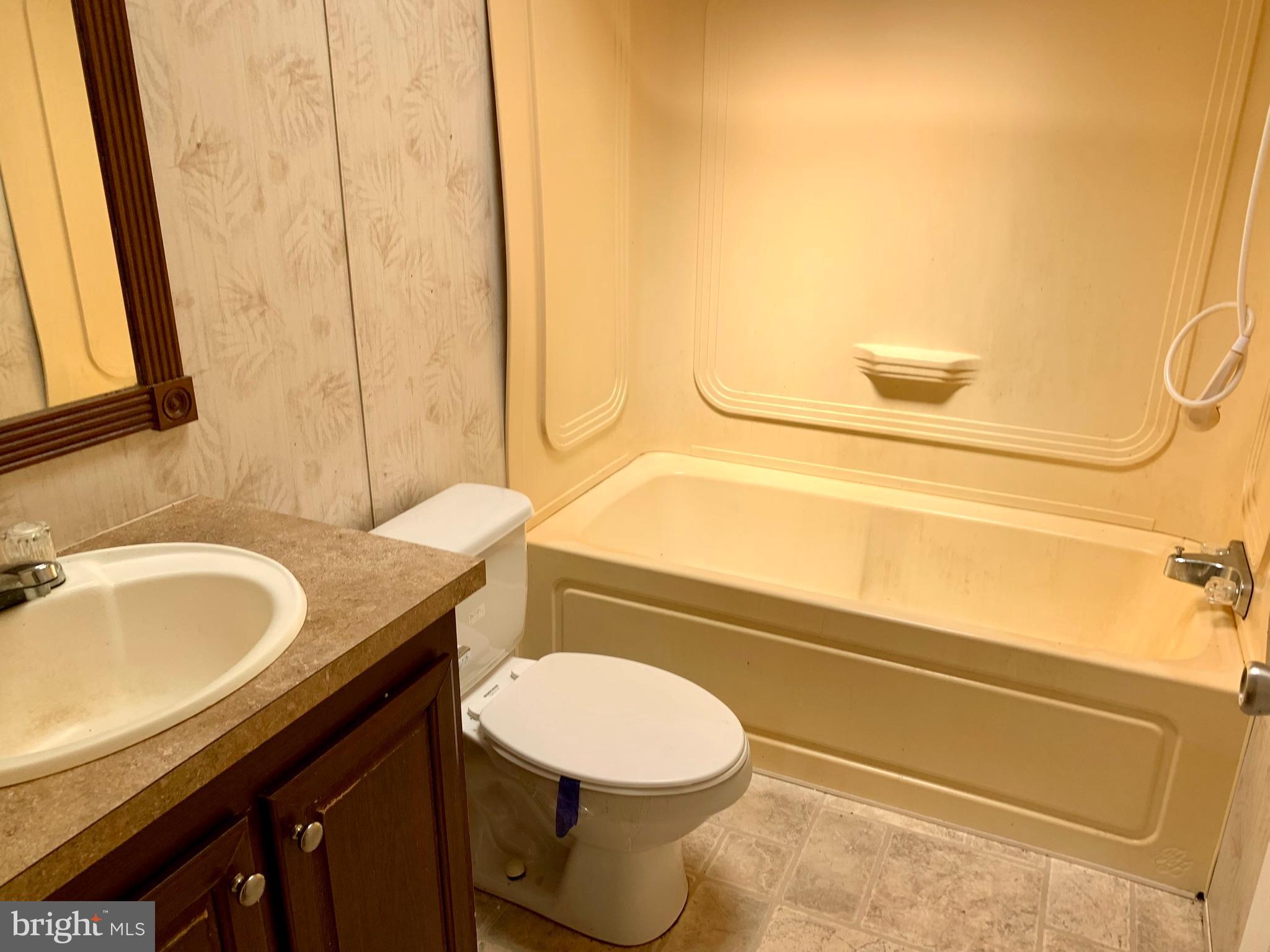 776 Pony Track Road Camden Wyoming, DE 19934 - Photo 18 of 18 a bathroom with a granite countertop sink toilet and a mirror