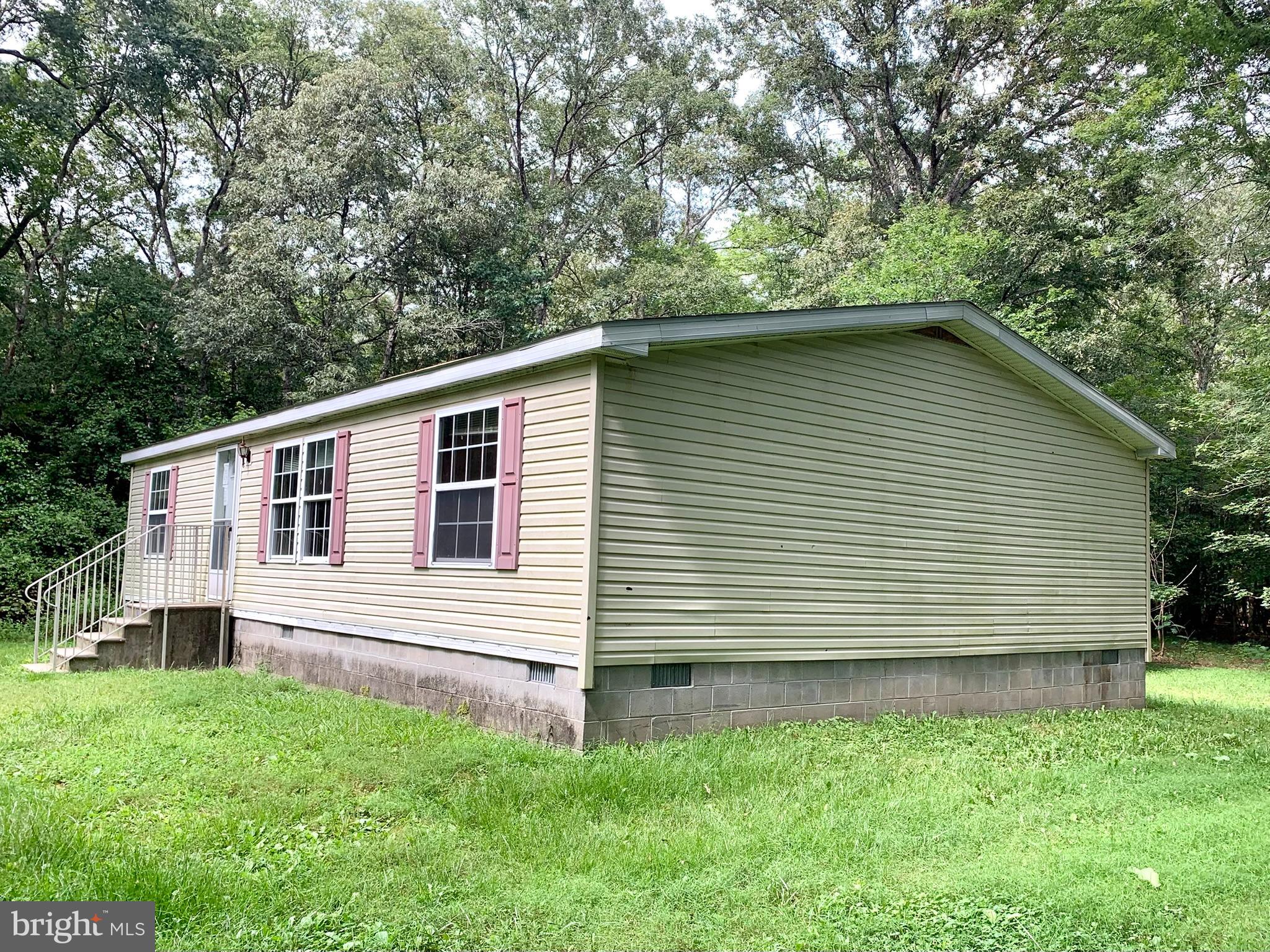 776 Pony Track Road Camden Wyoming, DE 19934 - Photo 4 of 18 a front view of a house with a garden