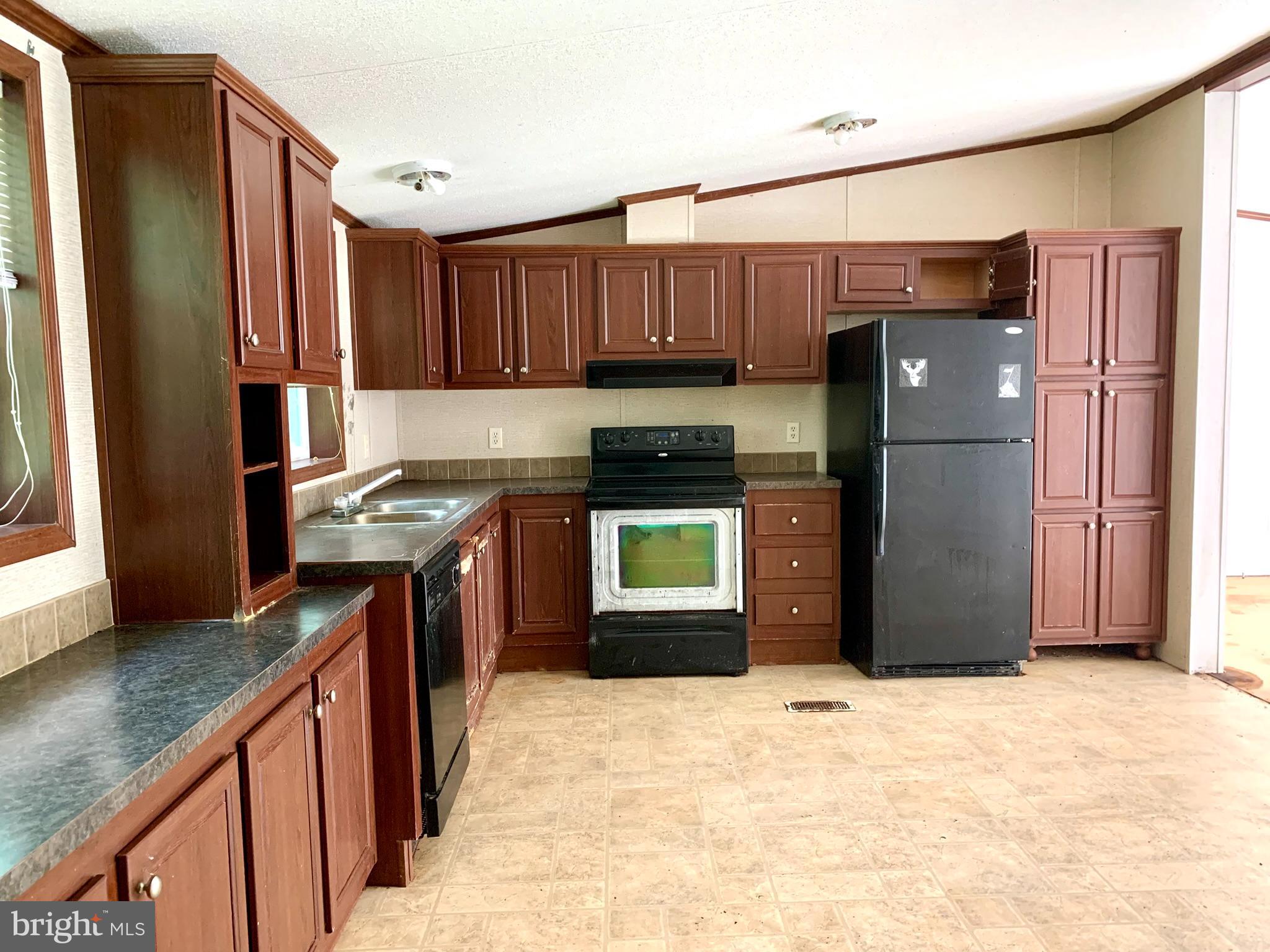 776 Pony Track Road Camden Wyoming, DE 19934 - Photo 9 of 18 a kitchen with stainless steel appliances granite countertop a refrigerator stove and a sink