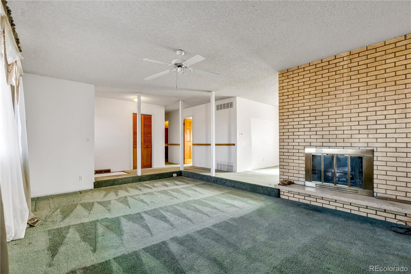 754 Highway 86 Elizabeth, CO 80107 - Photo 19 of 47 a view of an empty room with a fireplace and a window