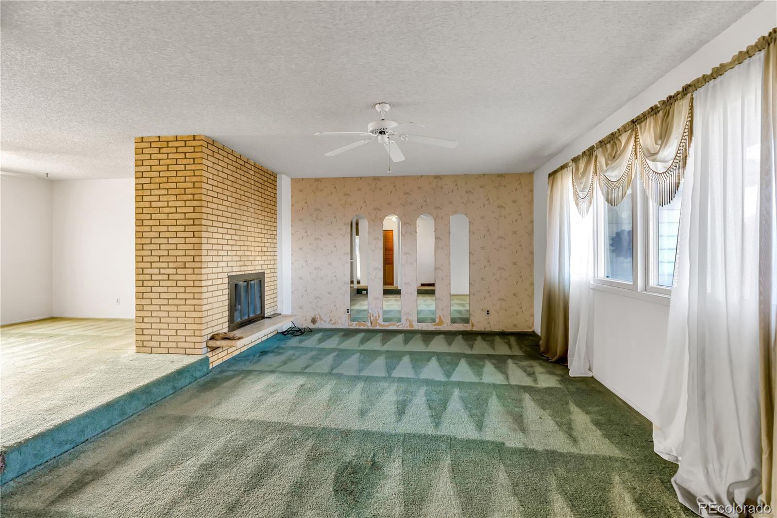 754 Highway 86 Elizabeth, CO 80107 - Photo 20 of 47 a view of an empty room with a fireplace and a window