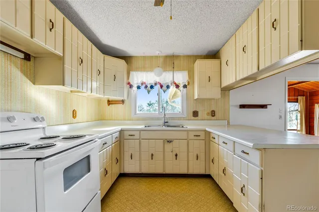 a kitchen with stainless steel appliances granite countertop a sink and cabinets
