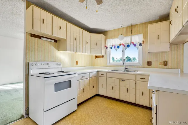 a kitchen with granite countertop a sink stainless steel appliances and cabinets