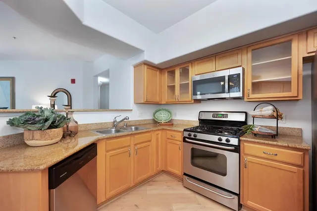 a kitchen with a sink stove top oven and microwave