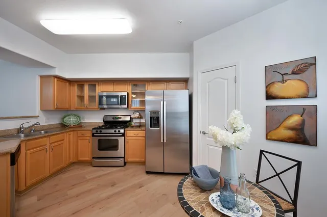 a kitchen with stainless steel appliances granite countertop a refrigerator and a stove