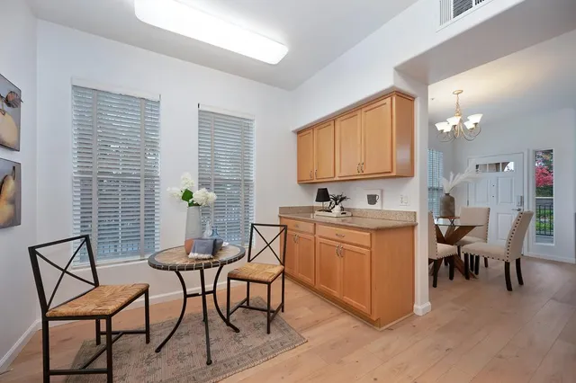 a view of a dining room with furniture and chandelier