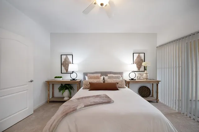 a bedroom with bed and window