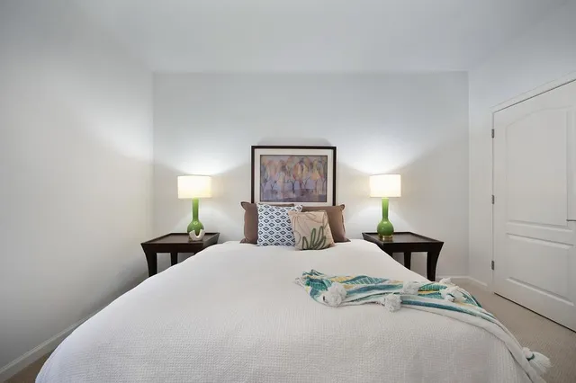 a bedroom with a bed and a lamp